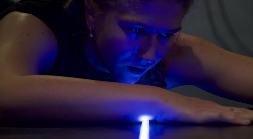 Close-up of a person with a light beam on their wrist