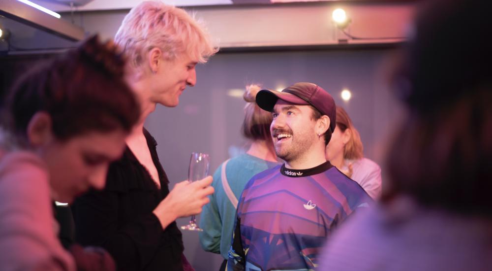 Two people talking at a party