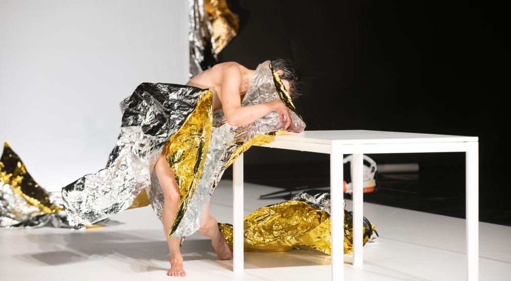 Manon Santkin wripped in tinfoil leaning on a table