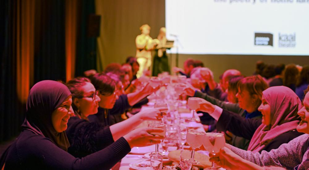 people raising glasses