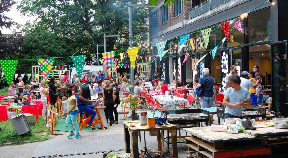 People sitting at festively laid tables eating spaghetti