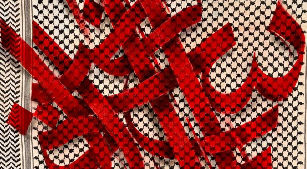 Arabic letters in red on a keffiyeh pattern