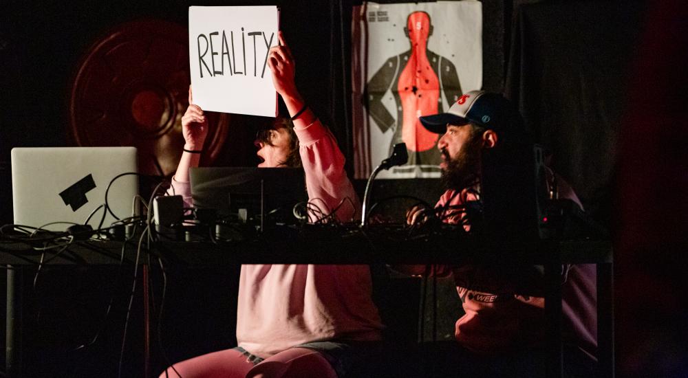 A person holding a sign that say Reality