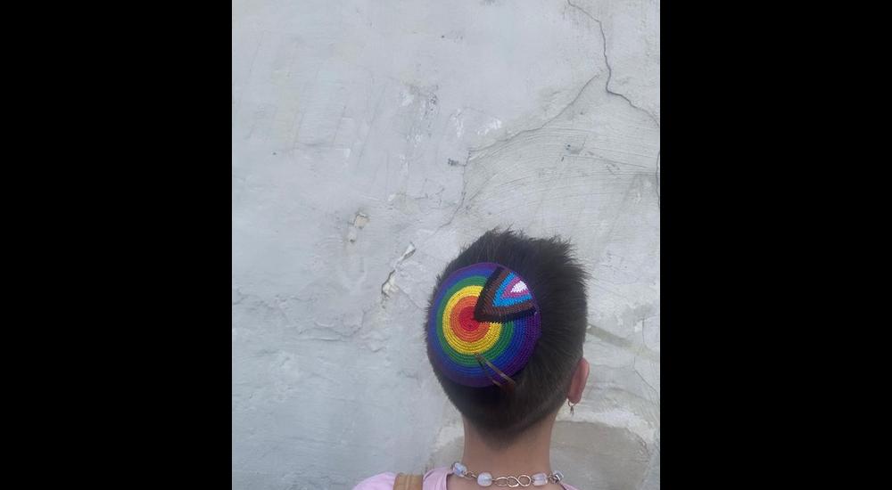 Person with rainbow kippa