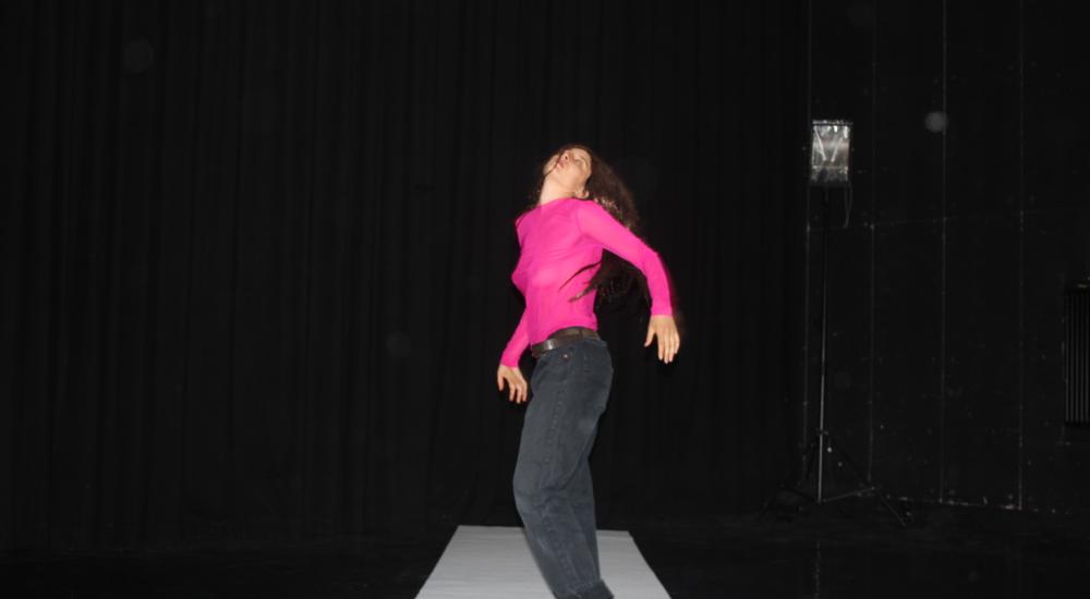 dancing girl with black jeans and pink shirt