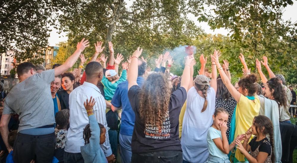 A crowd of people raising their arms