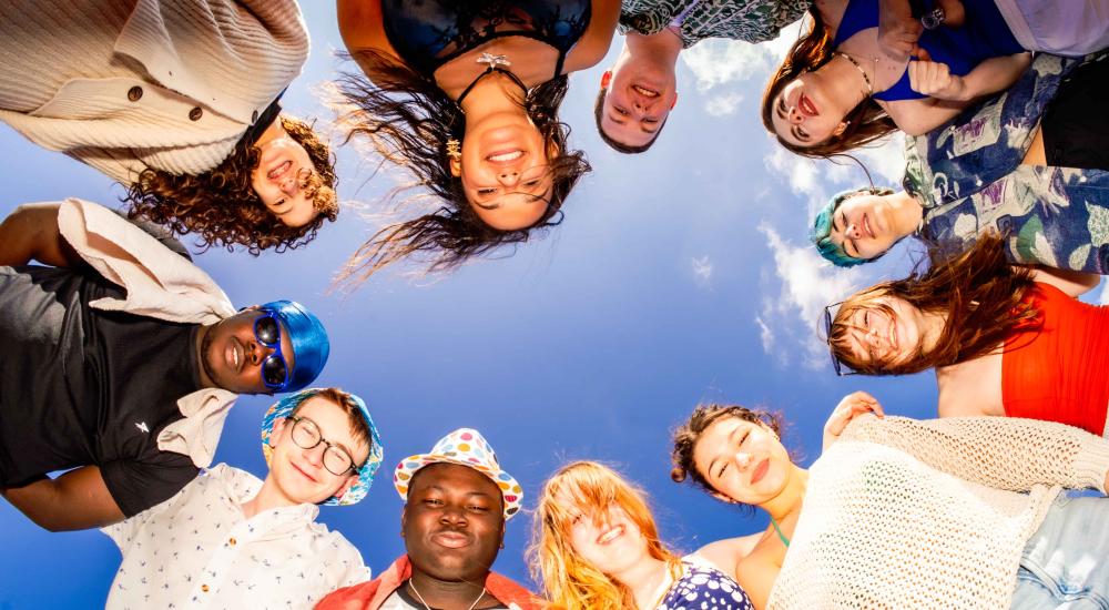The cast of the beach looking down at the camera