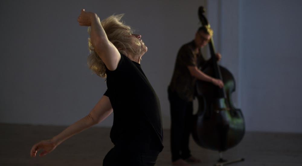 Dancing performer with double bass player