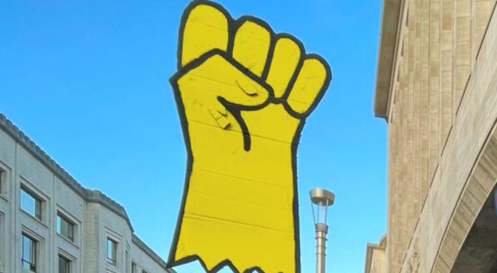 protest sign with yellow glove