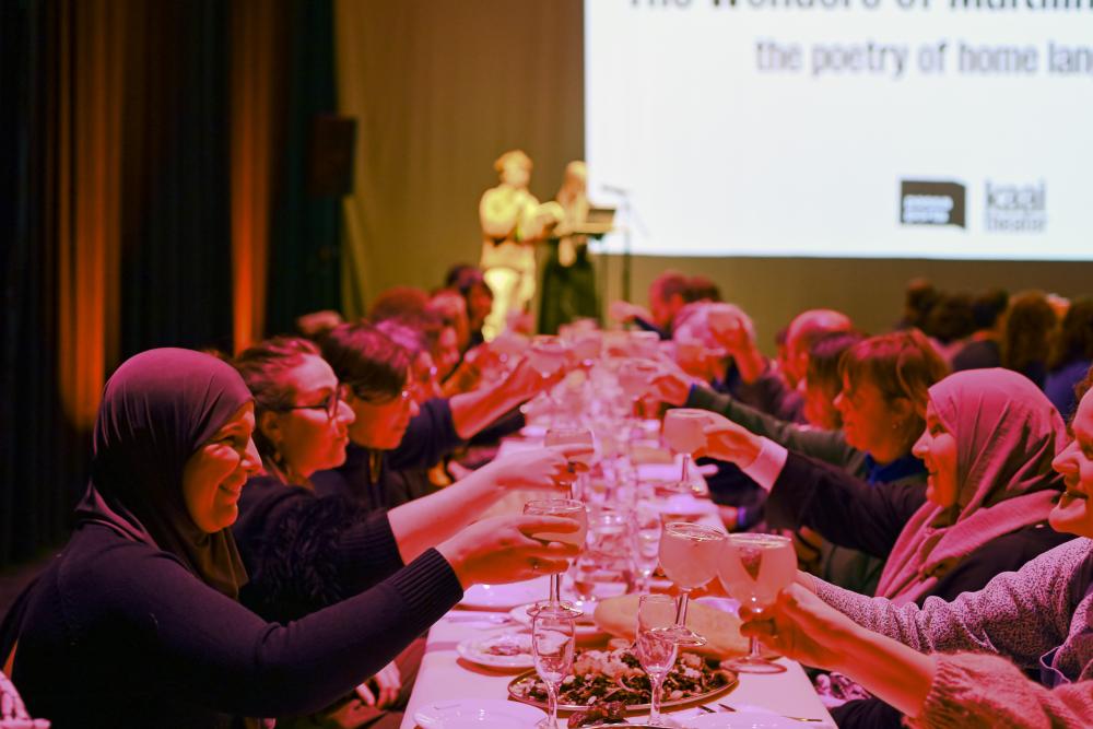 people raising glasses