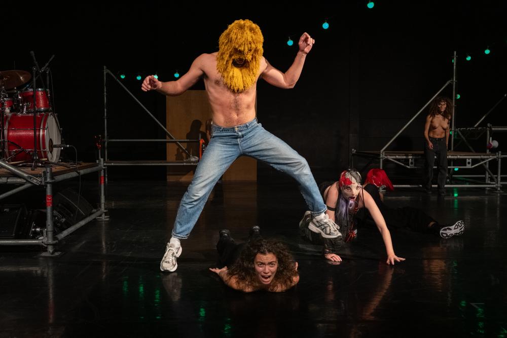 Three dancers, two on the floor, one jumping over them