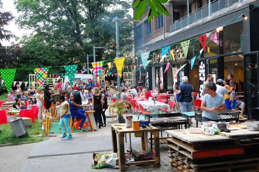 People sitting at festively laid tables eating spaghetti