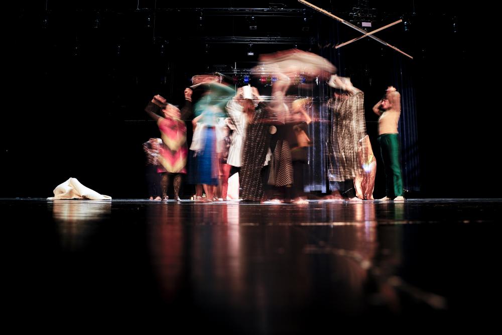 A blurry picture of a group of people in colourful clothes