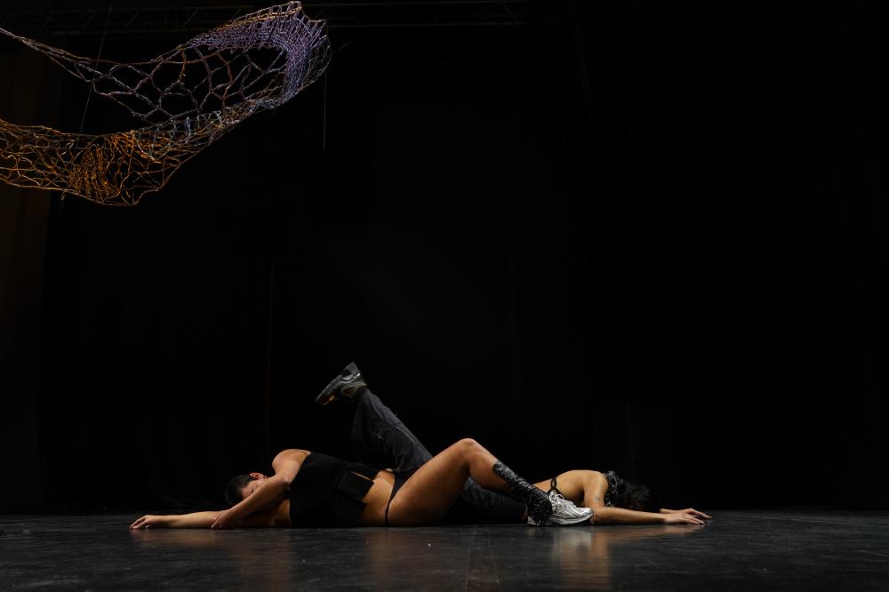 A dancer lying on her back