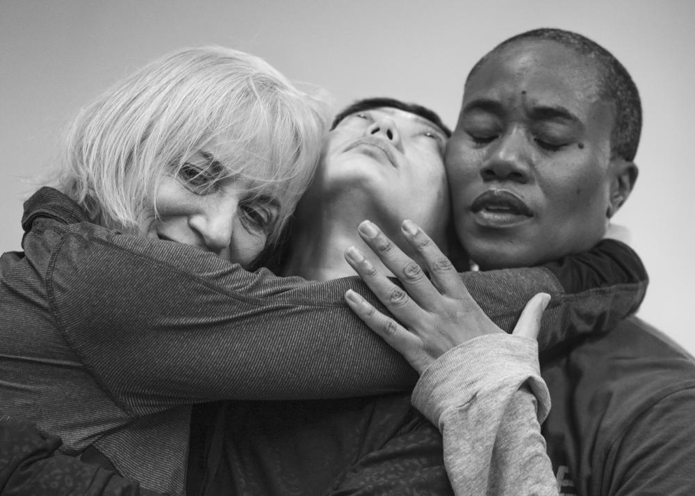 Meg Stuart, Mieko Suzuki and Omagbitse Omagbemi embracing