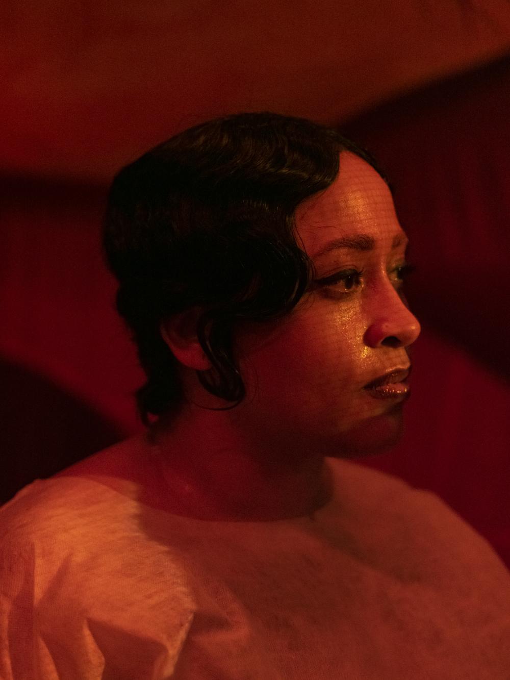 close up of a performer with a red spotlight on her