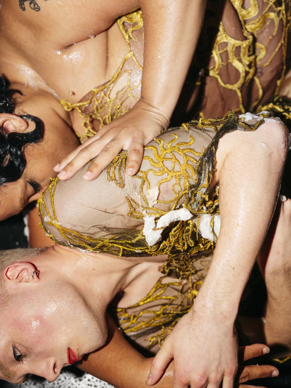 close up of two performers laying on the floor