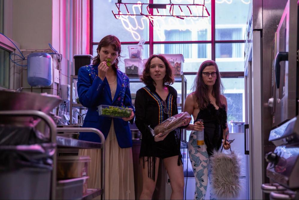 3 performers standing in a kitchen