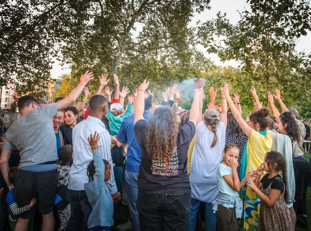 A crowd of people raising their arms