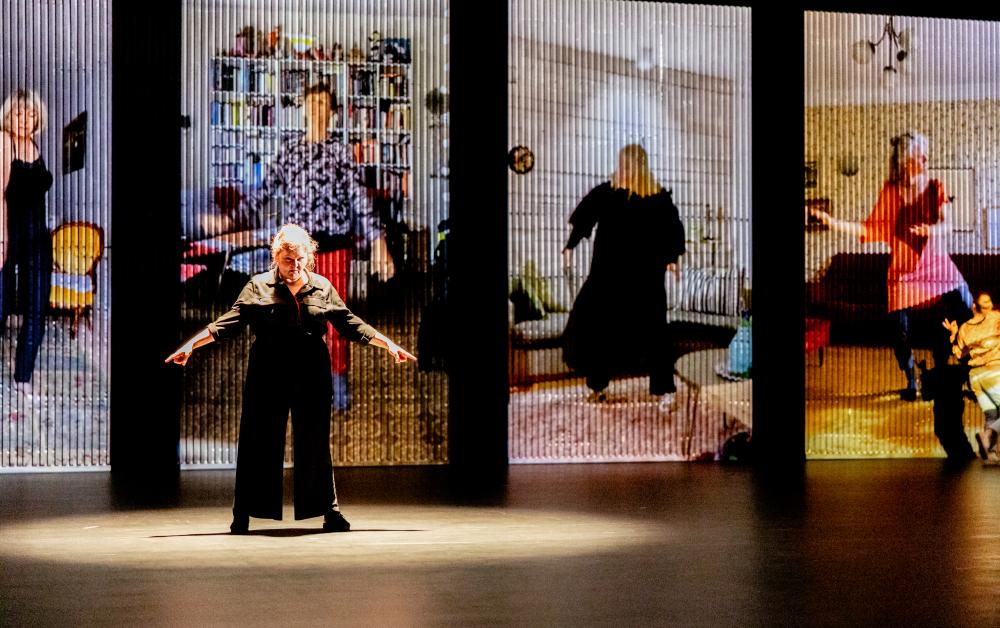 Dancer in front of screens on a stage