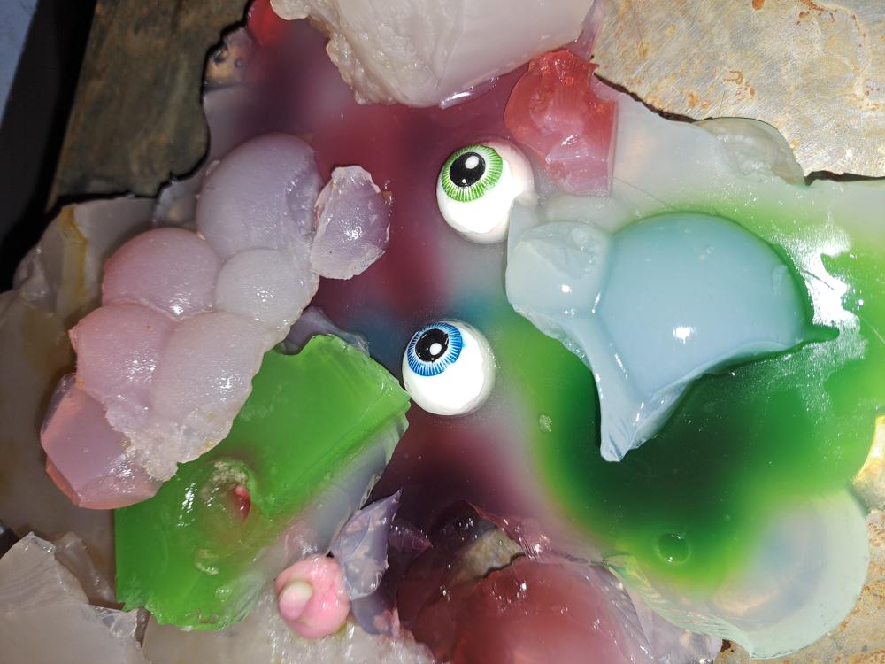 translucent, jelly-like blobs in different colors (pink, green, orange, and clear)