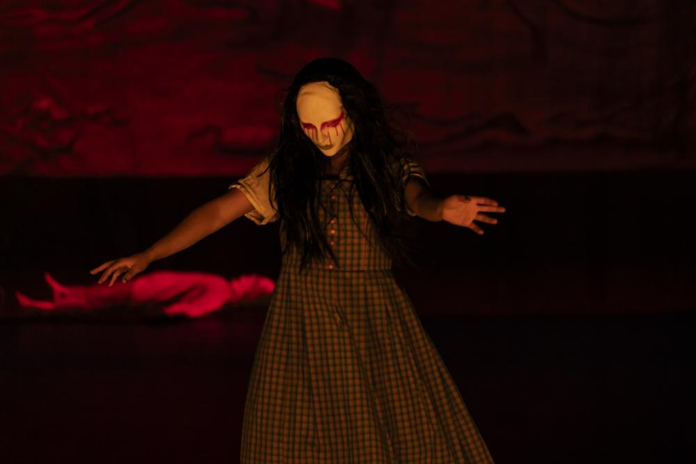 A dancer with white and red makeup on