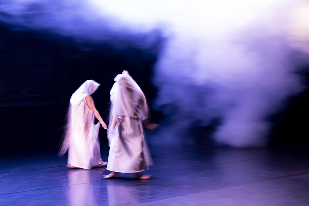 Two dancers wearing white dresses