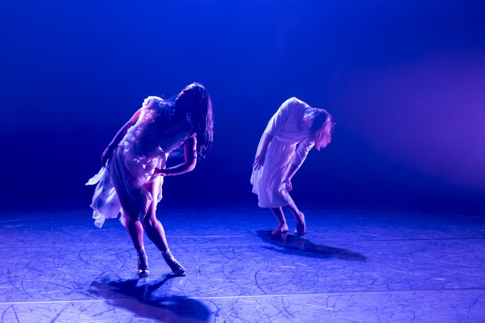 Two dancers in white dresses