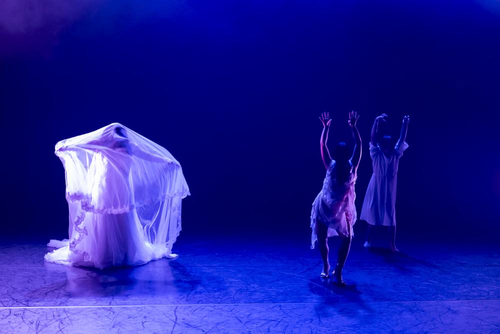 Three dancers in white dresses