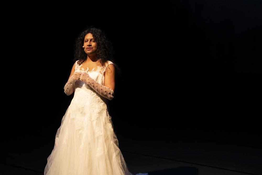Desirée on stage in a white wedding dress
