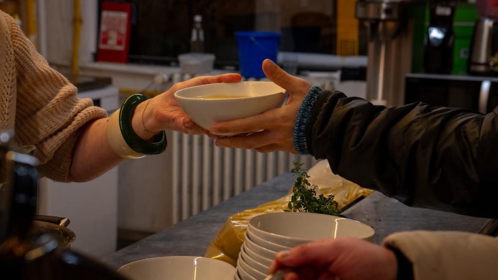 Someone handing over a bowl