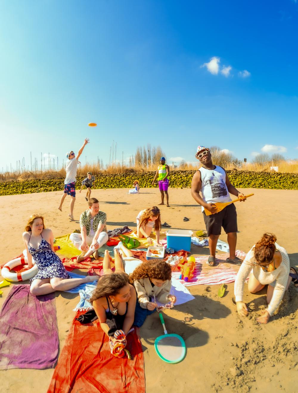 The cast playing on the beach