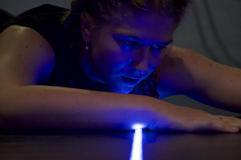 Close-up of a person with a light beam on their wrist