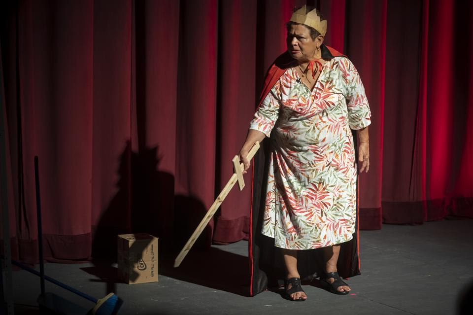 Josefina carrying a wooden sword and wearing a paper crown