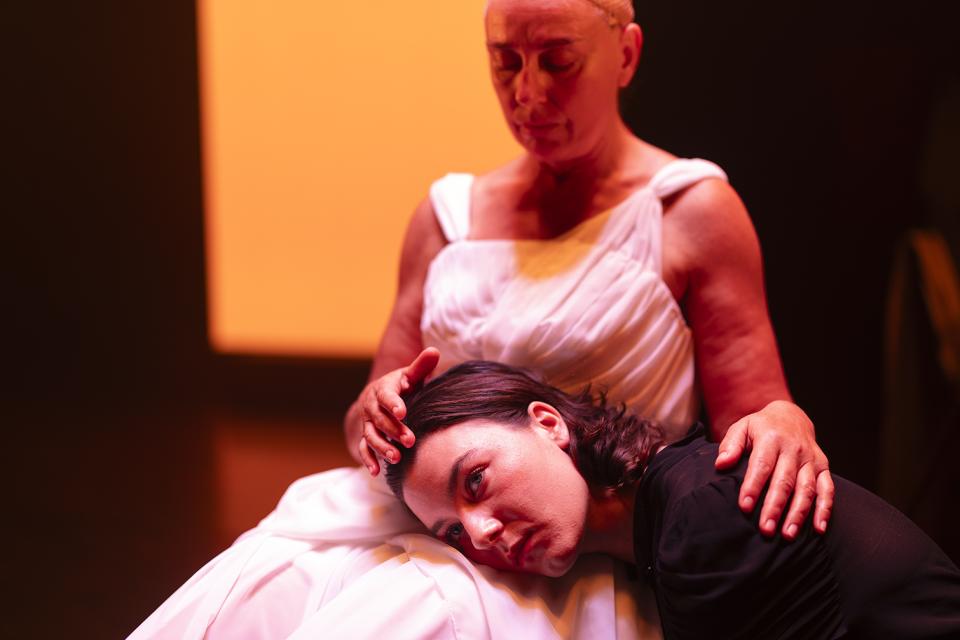two actors sitting on stage