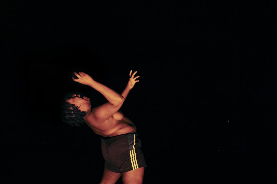 Black person in spotlight on stage 