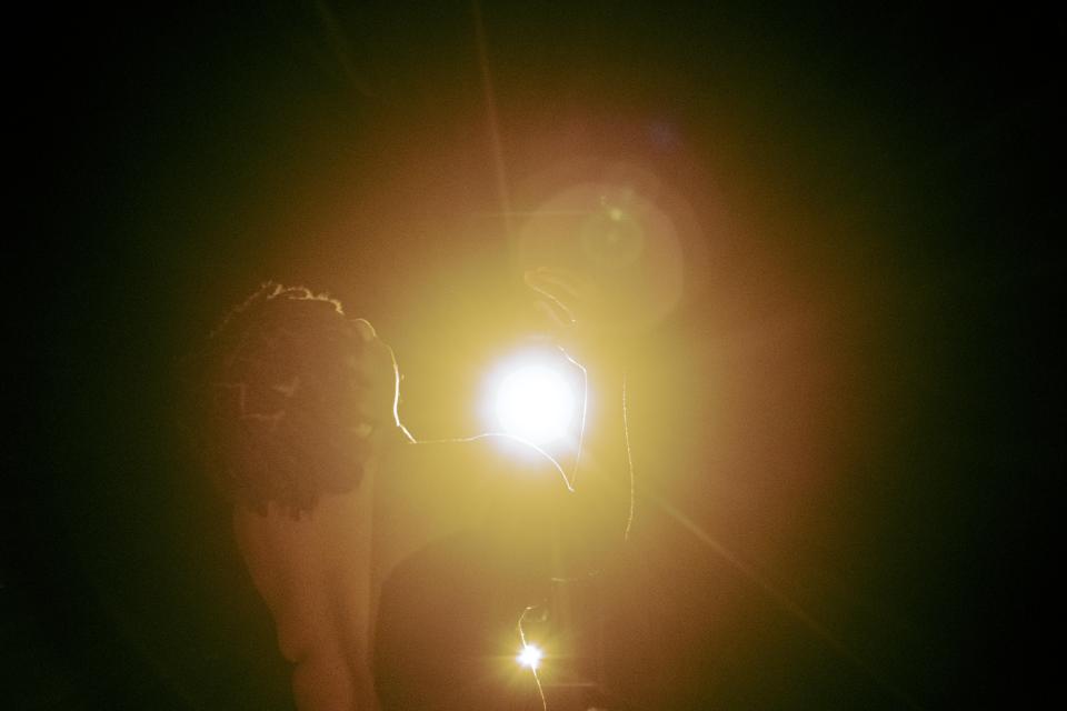 Black person in spotlight on stage 