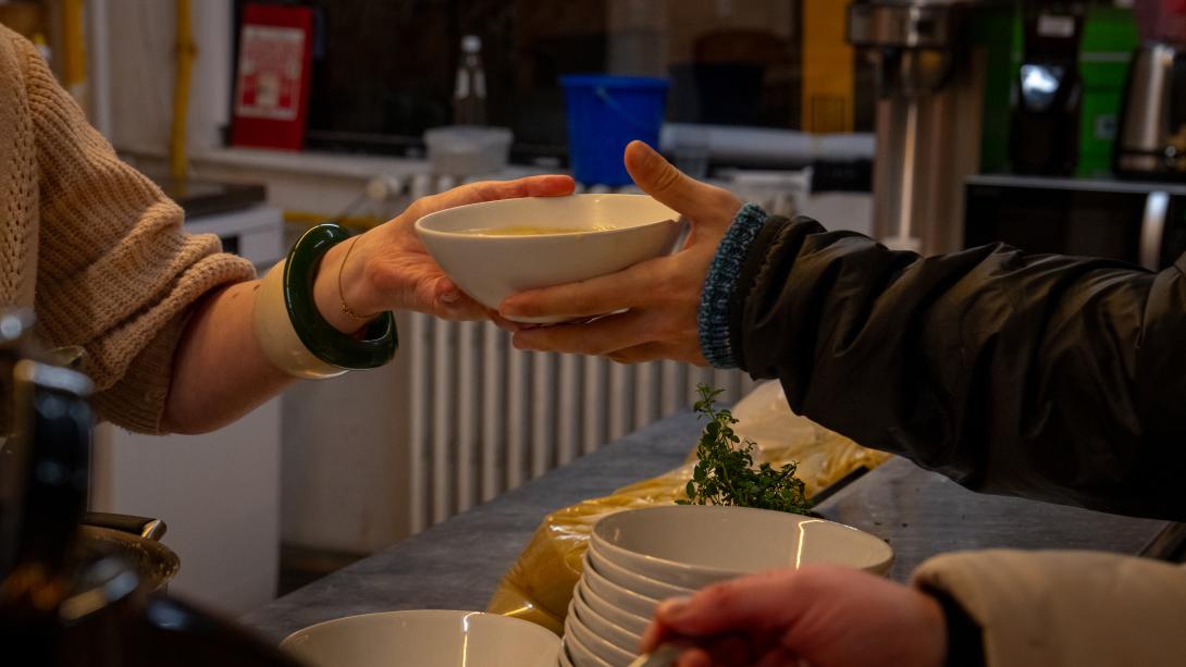Someone handing over a bowl